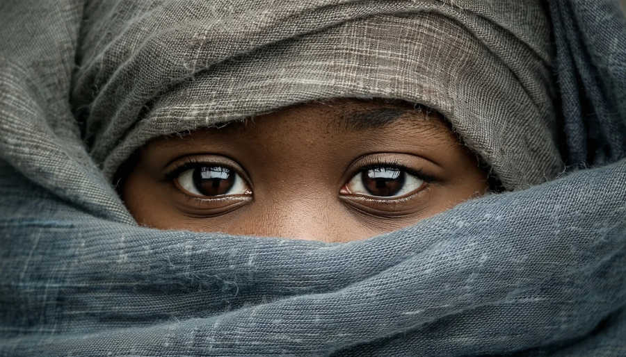 African child wrapped in handmade scarves 