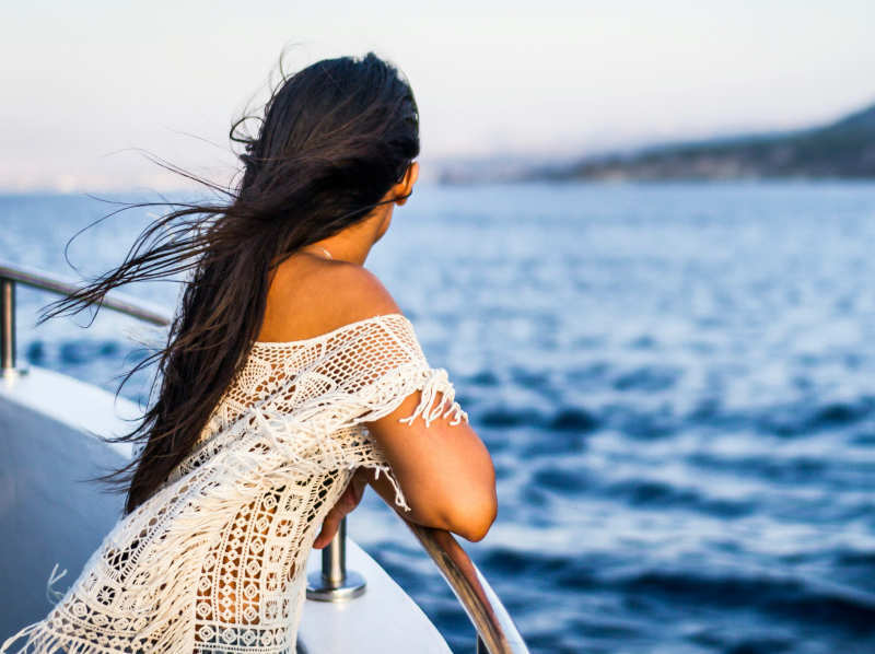 woman on cruise ship deck looking at the sea