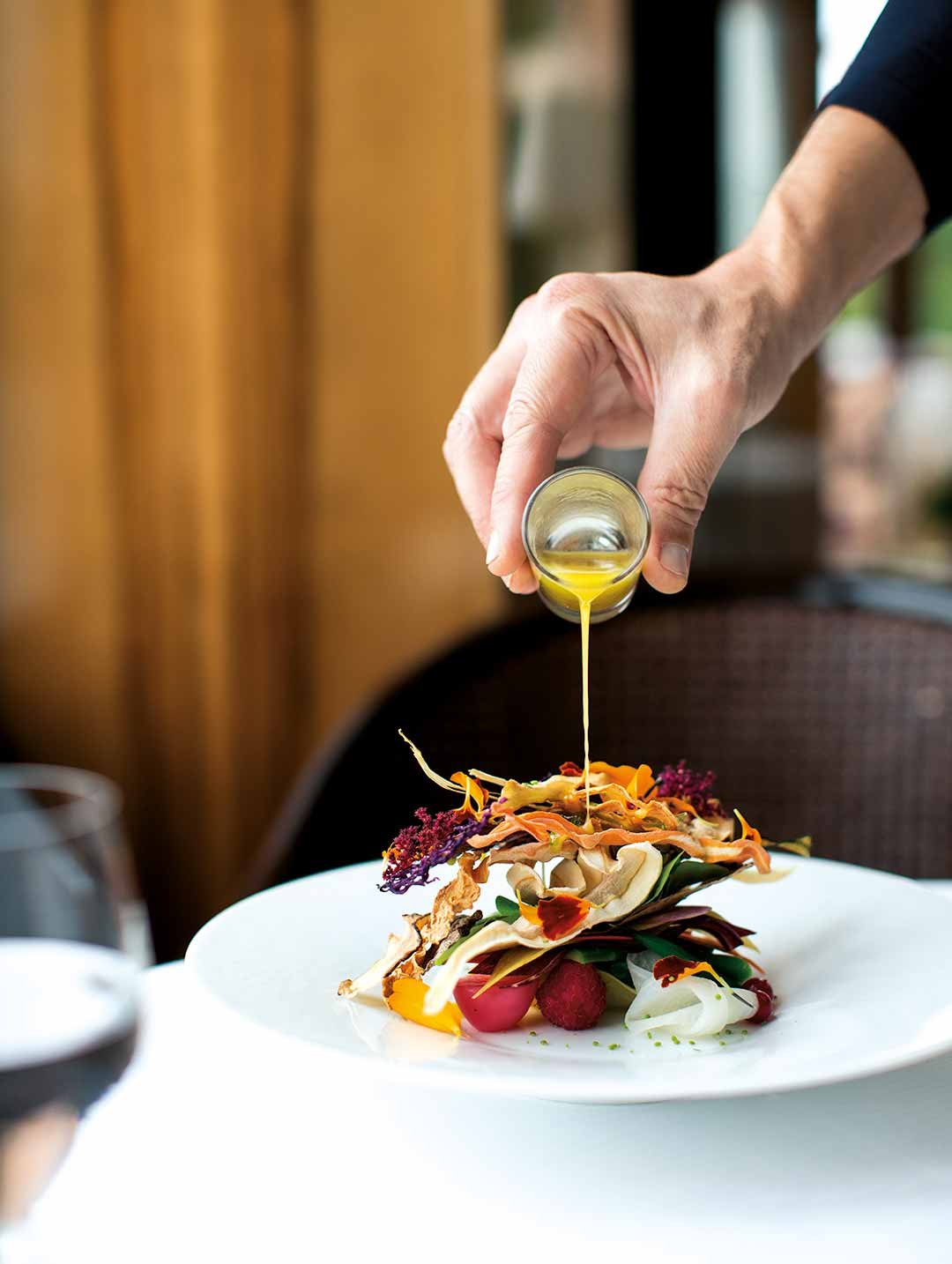 Pouring dressing on a salad